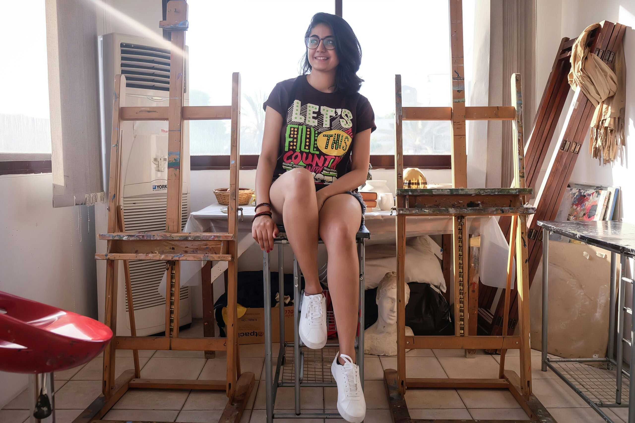 woman smiling sitting on a stool